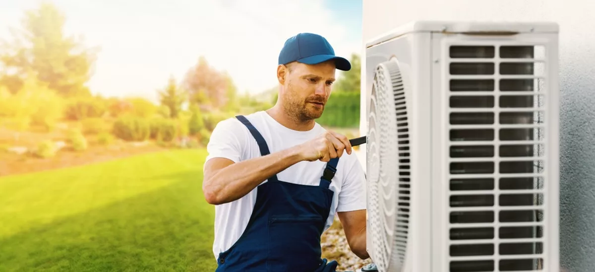 A technician working on a heat pump.